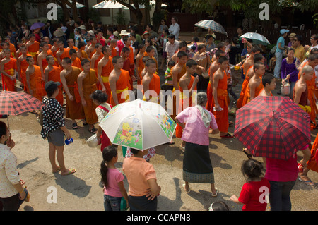 Buddhist monks in procession on Mue Nau, the middle day of Lao New Year (Pi Mai Lao), Luang Prabang, Laos Stock Photo