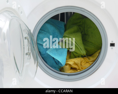 Colorful towels inside washing machine drum Stock Photo