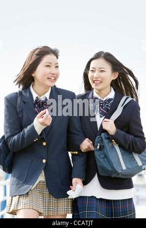 Two high school girls walking in the street Stock Photo - Alamy