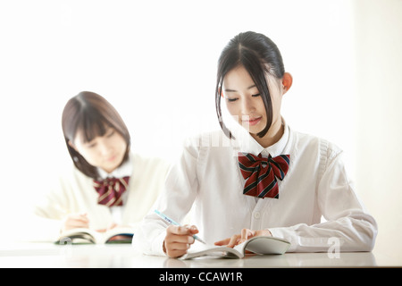 Two high school girls in class