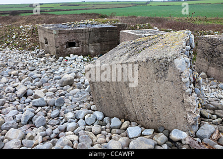 Second World War coastal defences on beach eroded by weather, Limpert Bay, Wales, UK Stock Photo