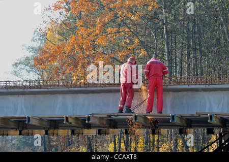 Construction workers working on the new bridge. Stock Photo