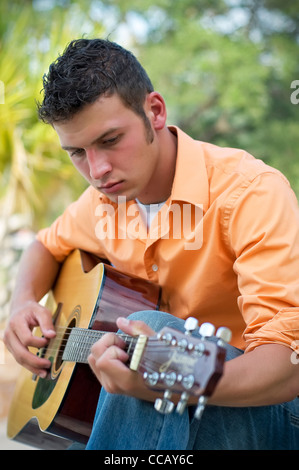 Young man playing guitar Stock Photo