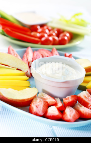 Raw fruits and vegetables with cream cheese and yogurt dip Stock Photo