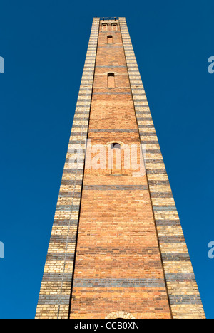 Decorative brick chimney against deep blue sky Stock Photo