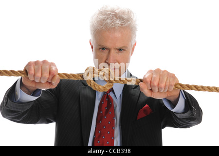 Businessman pulling a rope with knot isolated on a white background Stock Photo