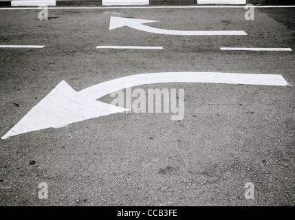 Road markings in Melaka in Malaysia in Far East Southeast Asia. Direction Arrow Divergence Street Scene Surreal Surrealism Travel Diverging Breaking Stock Photo