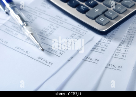 Prints of financial report on sheets with pen and calculator Stock Photo