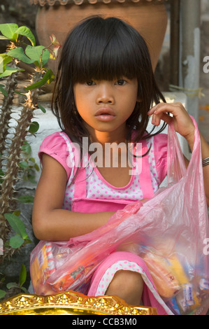 Lao girl waiting for sweets on Mount Phousi, on the first day of the new year, Lao New Year (Pi Mai Lao), Luang Prabang, Laos Stock Photo