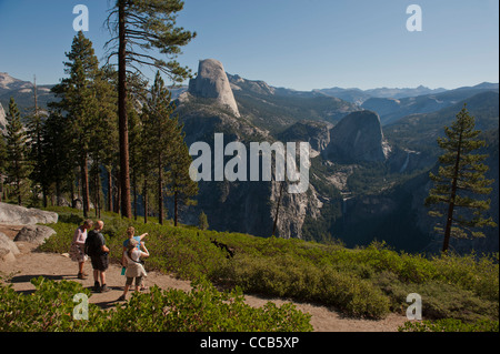 Hikers along the Panoramic Trail off Glacial Point. Yosemite National Park. California. USA Stock Photo