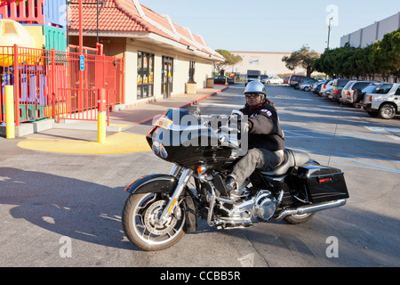 An African-American woman sitting on a Harley Davidson motorcycle Stock Photo