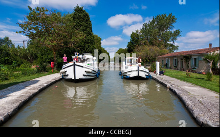 Two boats in a lock on the Canal du Midi - Southern France Stock Photo