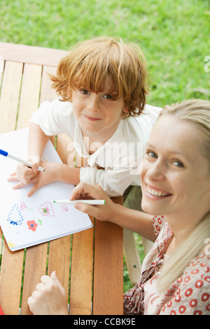 Mother and son coloring together, high angle view Stock Photo