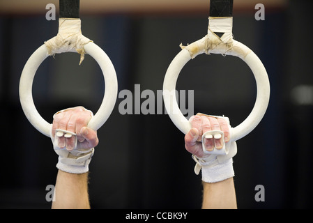 Gymnast's hands gripping the rings, cropped Stock Photo