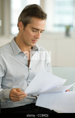 Businessman reading document Stock Photo