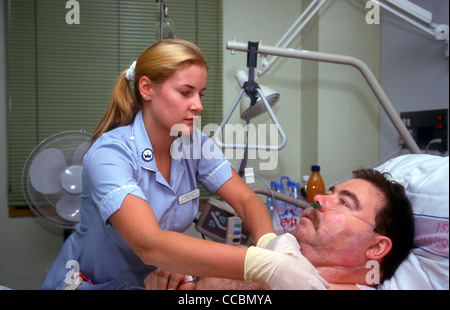 Nurse tending to patient on ward, Guys Hospital, London, UK. Stock Photo