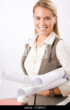 Female architect blueprints smiling hold standing on white background Stock Photo