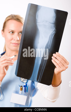 Young female doctor examining x-ray isolated on white background Stock Photo