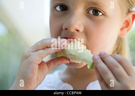 Little girl eatiing apple Stock Photo