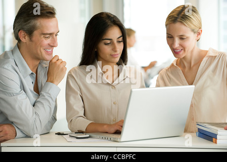 Colleagues working together on laptop computer Stock Photo