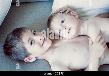 Little boy resting head on older brother's chest, portrait Stock Photo