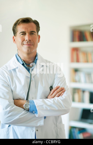 Doctor standing with arms folded, portrait Stock Photo
