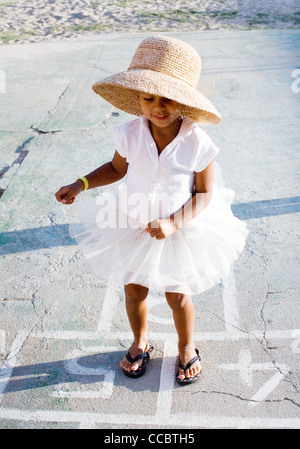 Little girl playing hopscotch Stock Photo