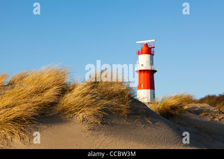 small lighthouse in the dunes at Borkum island Stock Photo