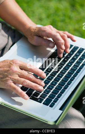 Senior woman using laptop Stock Photo