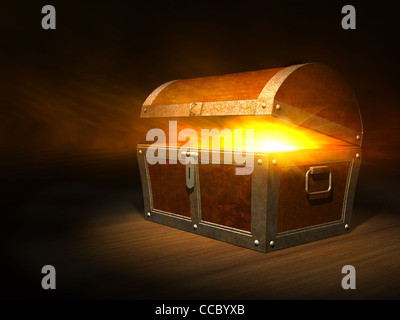 Old wooden treasure chest with strong glow from inside Stock Photo