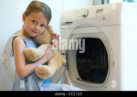 Little girl embracing teddy bear Stock Photo