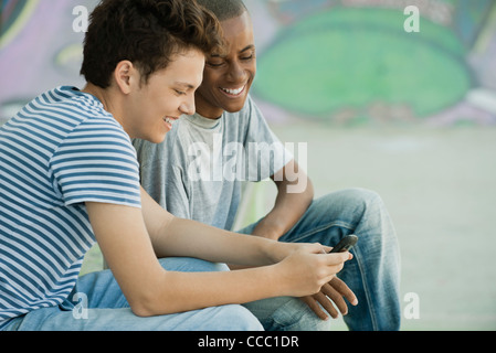 Young men looking at cell phone Stock Photo