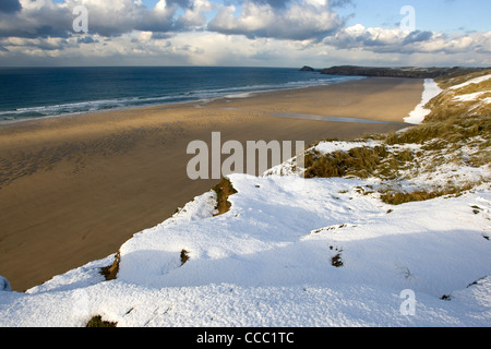 Snow on the coast path overlooking Perranporth beach, Cornwall. Stock Photo