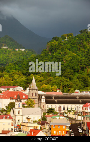 Sunlight warms the town of Roseau under stormy skies, Dominica, Leeward Islands, West Indies Stock Photo