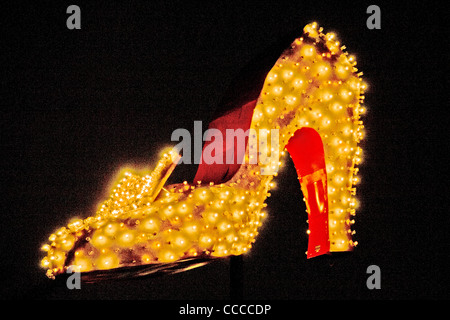 A giant illuminated high heel shoe decorates Las Vegas Boulevard in Las Vegas, NV, as part of the 'Neon Boneyard Park' signs. Stock Photo