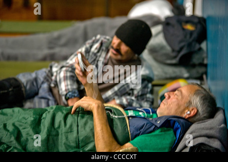 Homeless men prepare to sleep at a night shelter held at a church in