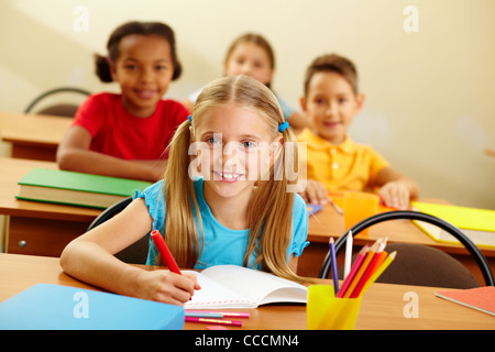 Portrait of lovely girl looking at camera at lesson Stock Photo