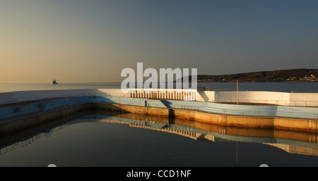 The Bathing Pool at Penzance, West Cornwall looking out over Mount's Bay towards Mousehole. Captured in early morning light. Stock Photo