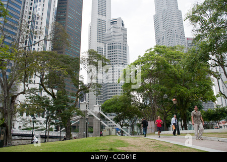 People walk through the central business district of Singapore Stock Photo