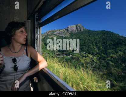 European tourist watching countryside in Train Intercity Express Kandy-Colombo, Sri Lanka Stock Photo
