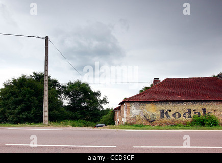 Old Kodak Advertising Mural on Farmhouse Wall in rural France Wide View Stock Photo