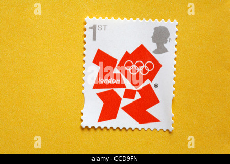 1st class London 2012 Olympics postage stamp on yellow envelope - first class postage stamp Stock Photo