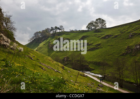 Walkers beside the River Dove in Wolfscote Dale, Peak District National Park, Derbyshire, England Stock Photo