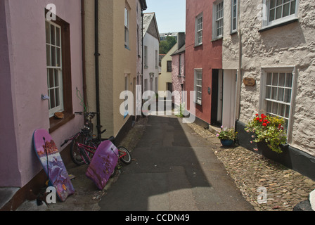 Typical street in a traditional Cornish fishing village. Cawsand, East Cornwall. Children's bikes and body-boards left outside. Stock Photo