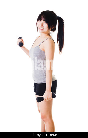 Chinese woman doing bicep curls with small hand weights. Stock Photo