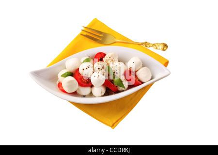 Bowl of mozzarella cheese, tomato and basil Stock Photo