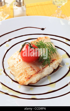 Salmon trout fillet garnished with arugula and balsamic reduction Stock Photo