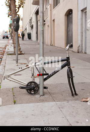 Vandalized bicycle on sidewalk (vandalized bike frame) - USA Stock Photo