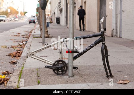 Vandalized bicycle on sidewalk (vandalized bike frame) - USA Stock Photo