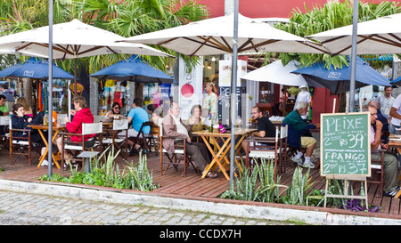 People enjoying a meal at an outdoor restuarant in Armacao dos Buziou Brazil. Stock Photo